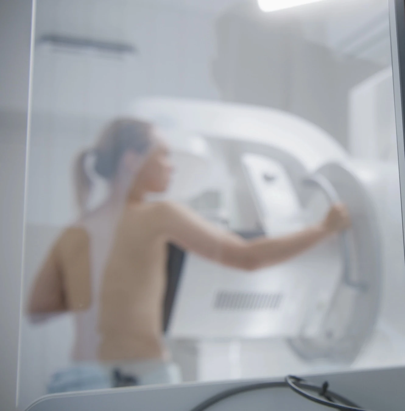 Patientin an einem medizinischen Untersuchungsgerät.